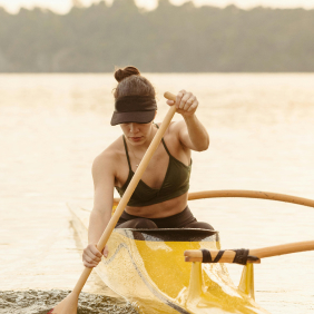 Photo of woman paddling yellow canoe