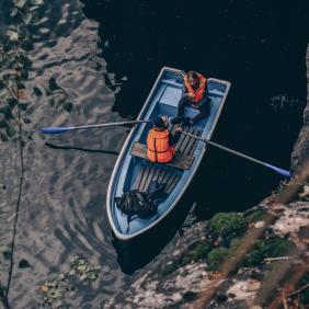 Sky view of 3 peope on a fishing boat